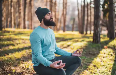 man meditating in a forest