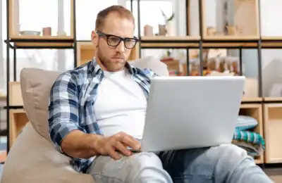 man sitting with laptop concentrating