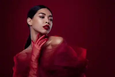 A woman with smoky eye make up and red lipstick wearing red netting