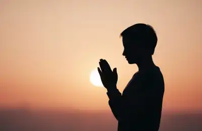 person praying at sunset