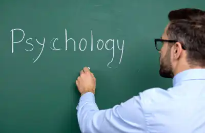 Image of someone writing 'psychology' on a chalk board.
