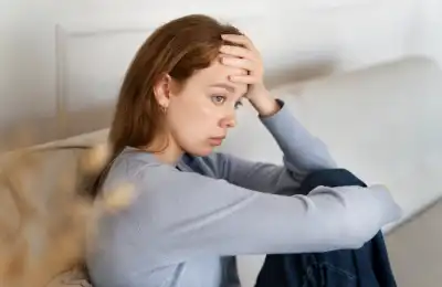 Image of someone with their head in their hands.