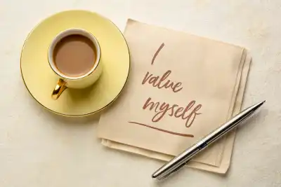'I value myself' written on a napkin next to a coffee
