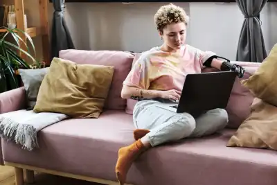 woman using laptop on sofa