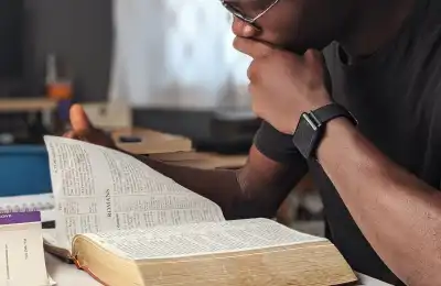 Image of someone looking at the Bible.