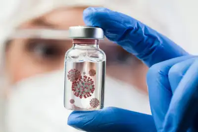 A blurred scientist in the background holding a little glass bottle containing a virus