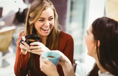 two women chatting with coffee