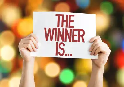 A sign being held up that says 'the winner is...'