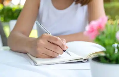 woman writing in notebook