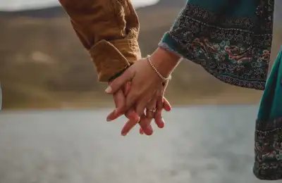 man and woman holding hands boho