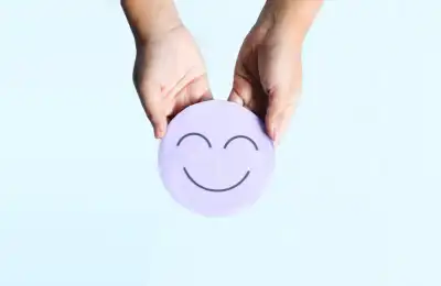 person holding purple smiling face to represent mental health