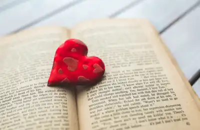 open book with red felt love heart on top