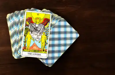 Image of a tarot card deck with the lovers card on top.