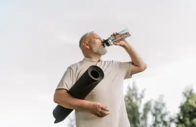 man with yoga mat drinking water
