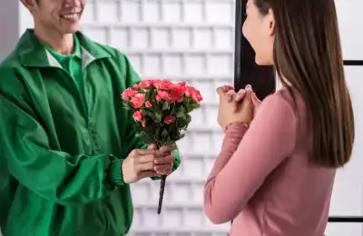 Image of someone giving somoene else a bouquet of flowers.