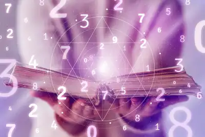 An open book with lots of different numbers surrounding it