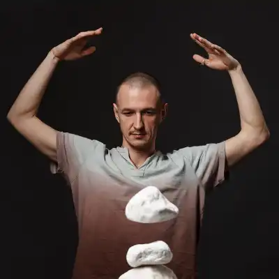 A man making a stone levitate with telekinesis