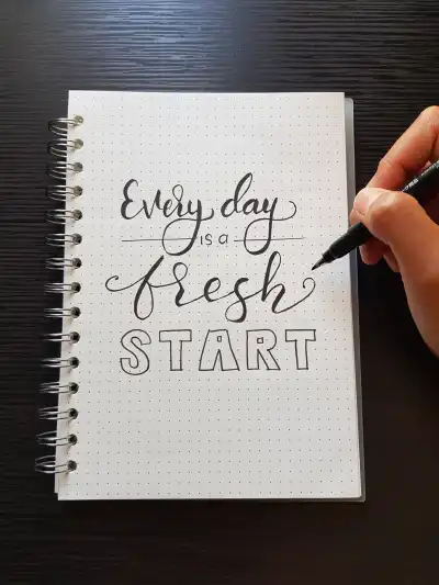 A notebook that reads "every day is a fresh start".