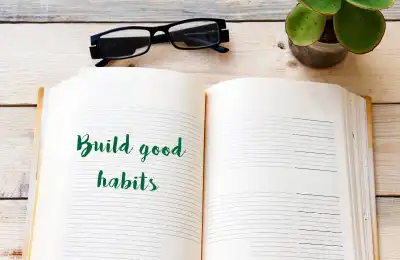 Image of a notebook that says 'Build Good Habits.'