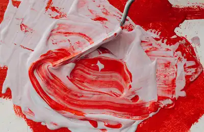 Image of red and white paint being mixed.