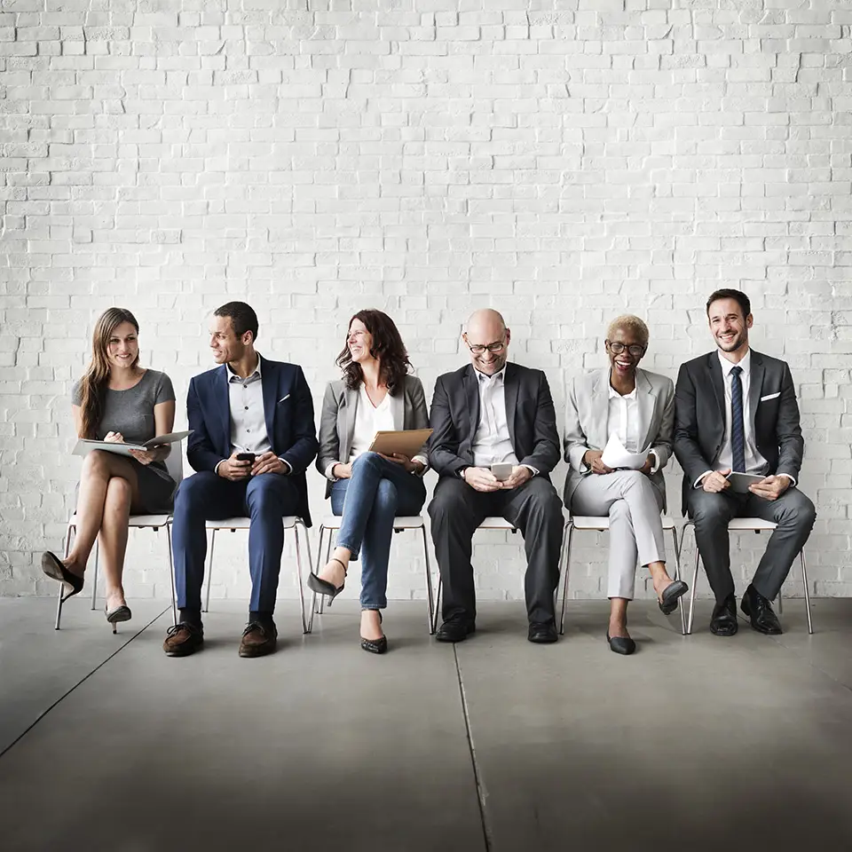 A group of people in business suits sat down next to each other