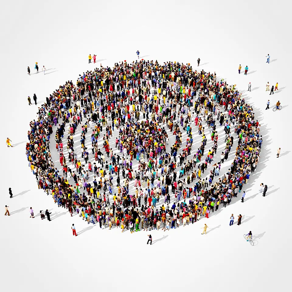 Large and diverse group of people seen from above gathered together in the shape of a concentric circles