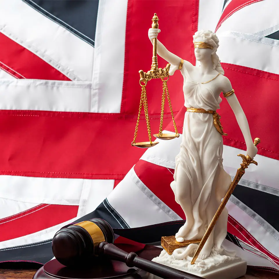 Flag of the United Kingdom with a statue of the goddess Justitia and a wooden gavel