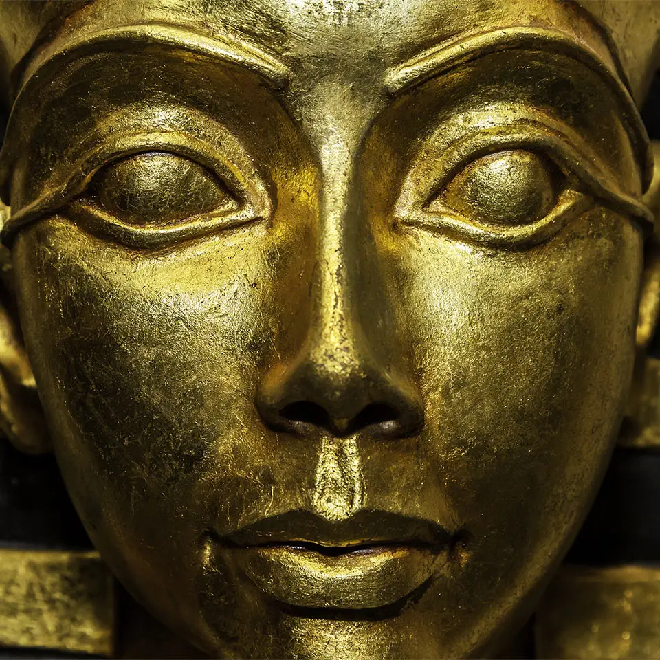 Golden-coloured sculpture of a pharaoh’s face