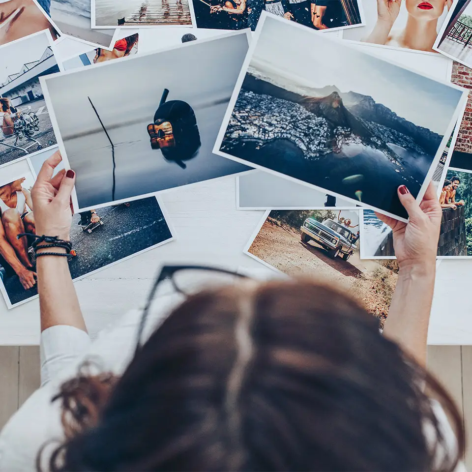 Top view of a photographer working in a studio looking through prints