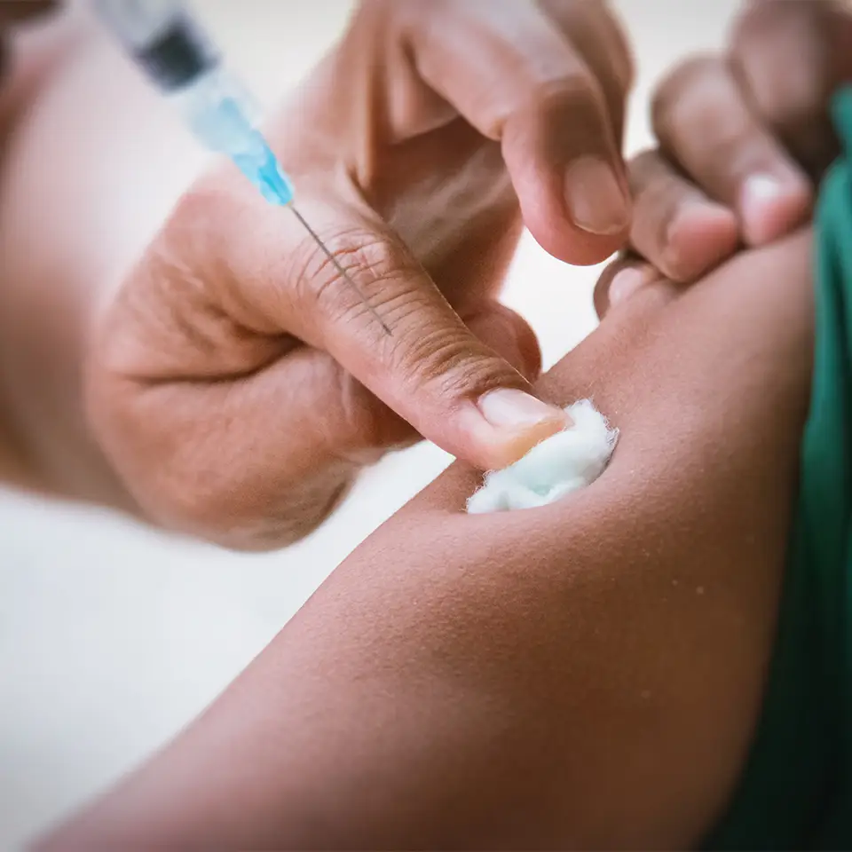 A doctor injecting a vaccine into a patient’s arm