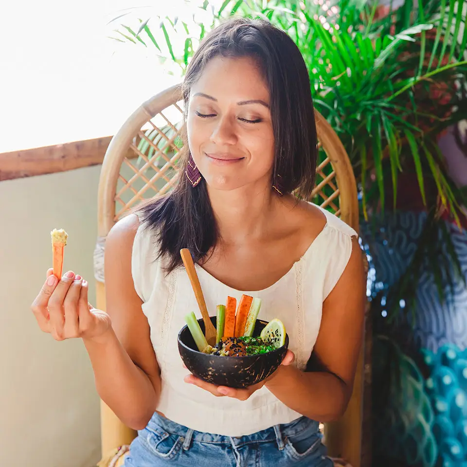 Woman smiling as she’s about to eat a bowl of healthy food