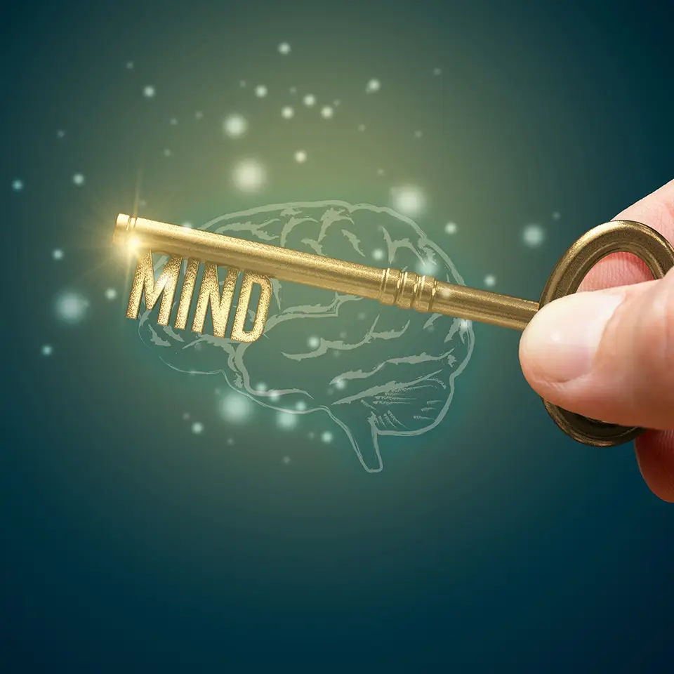 A key, shaped into the word mind above an illustration of a brain