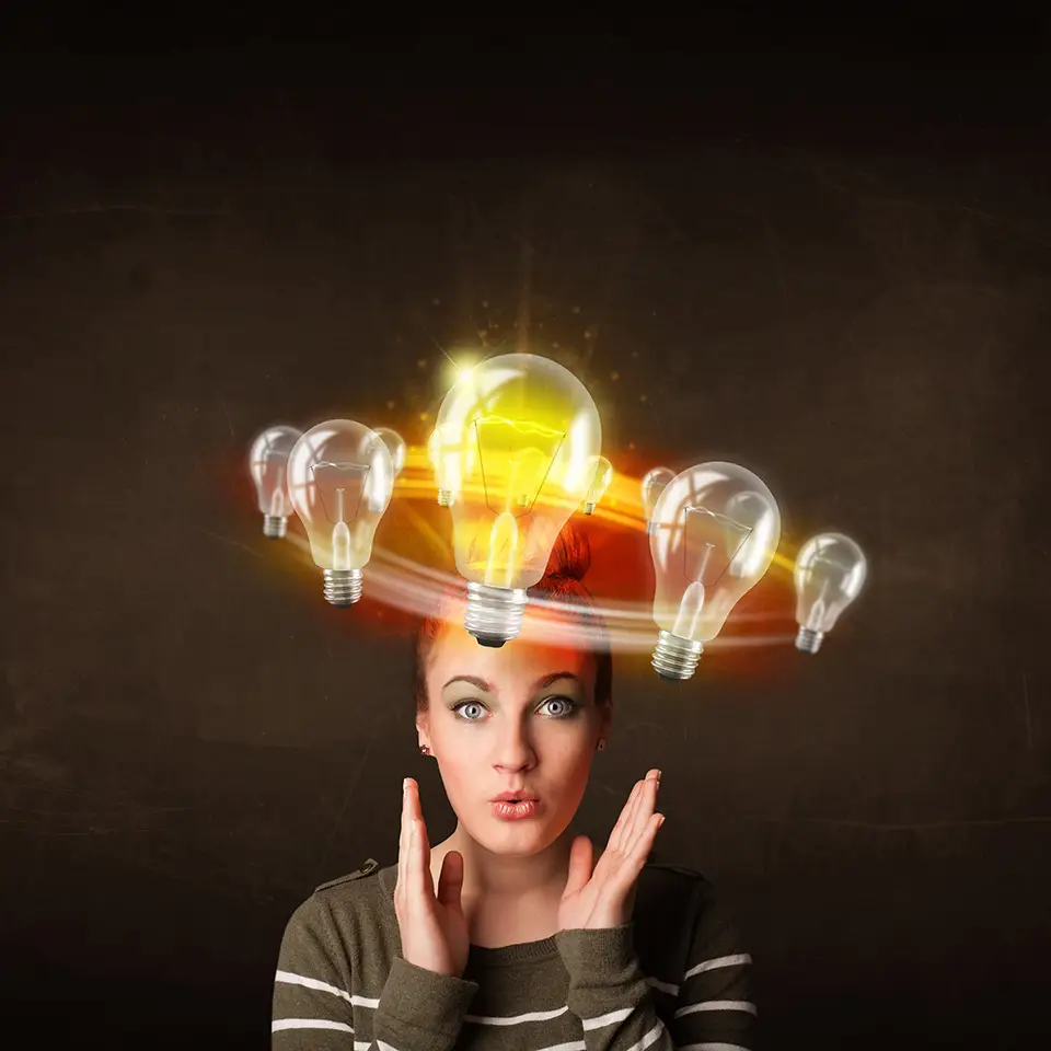 Woman with light bulbs circling around her head - one of them is brightly lit