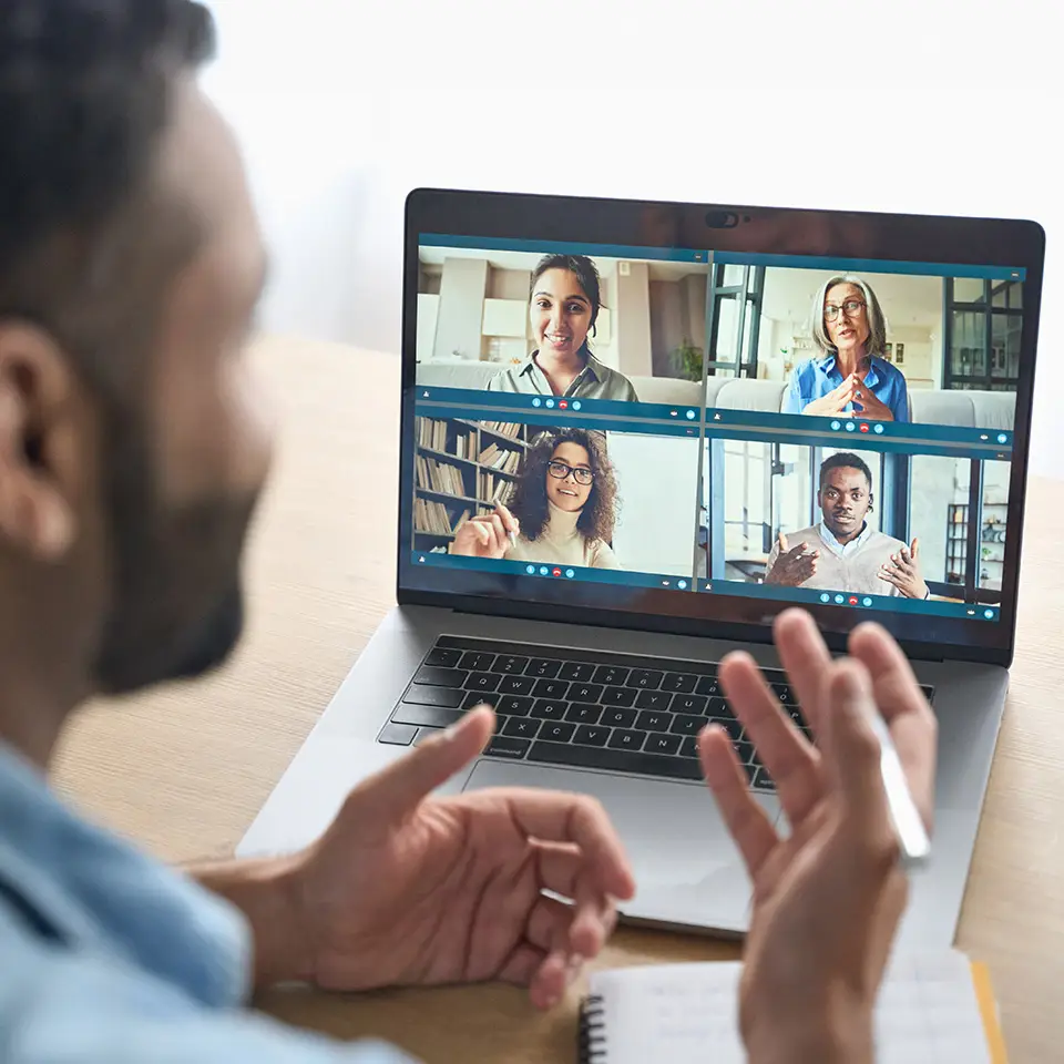 Man having virtual team meeting group on a laptop