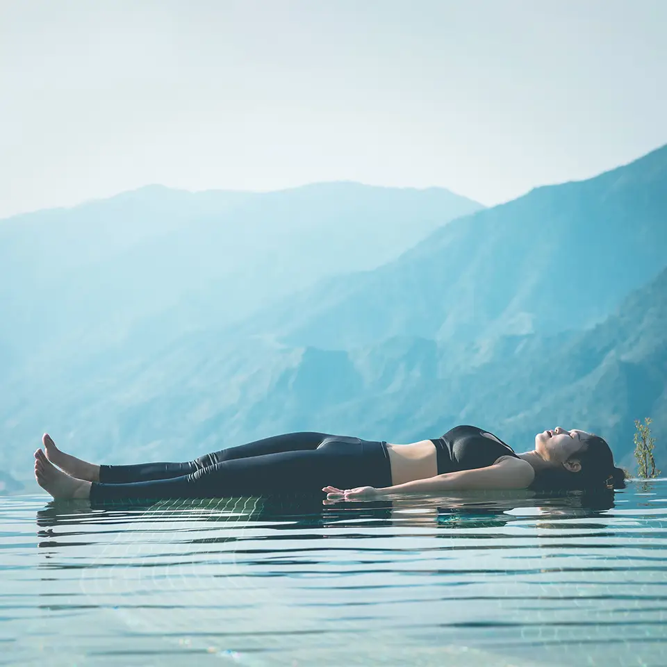 Person practicing Yoga Nidra seemingly floating on a body of water