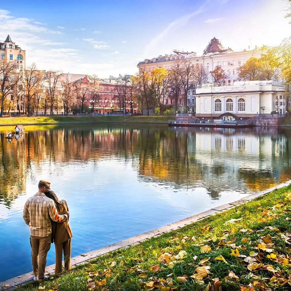 A couple embracing beside the Patriarch's Ponds on a sunny autumn day in Moscow