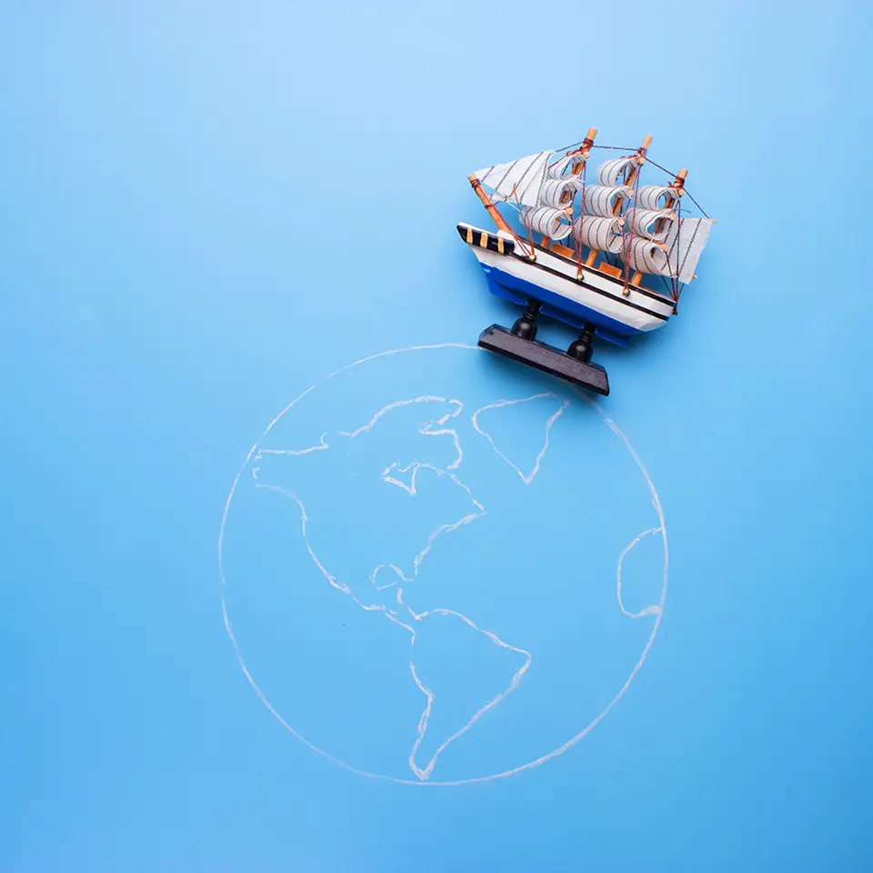 Model ship on a drawing of earth