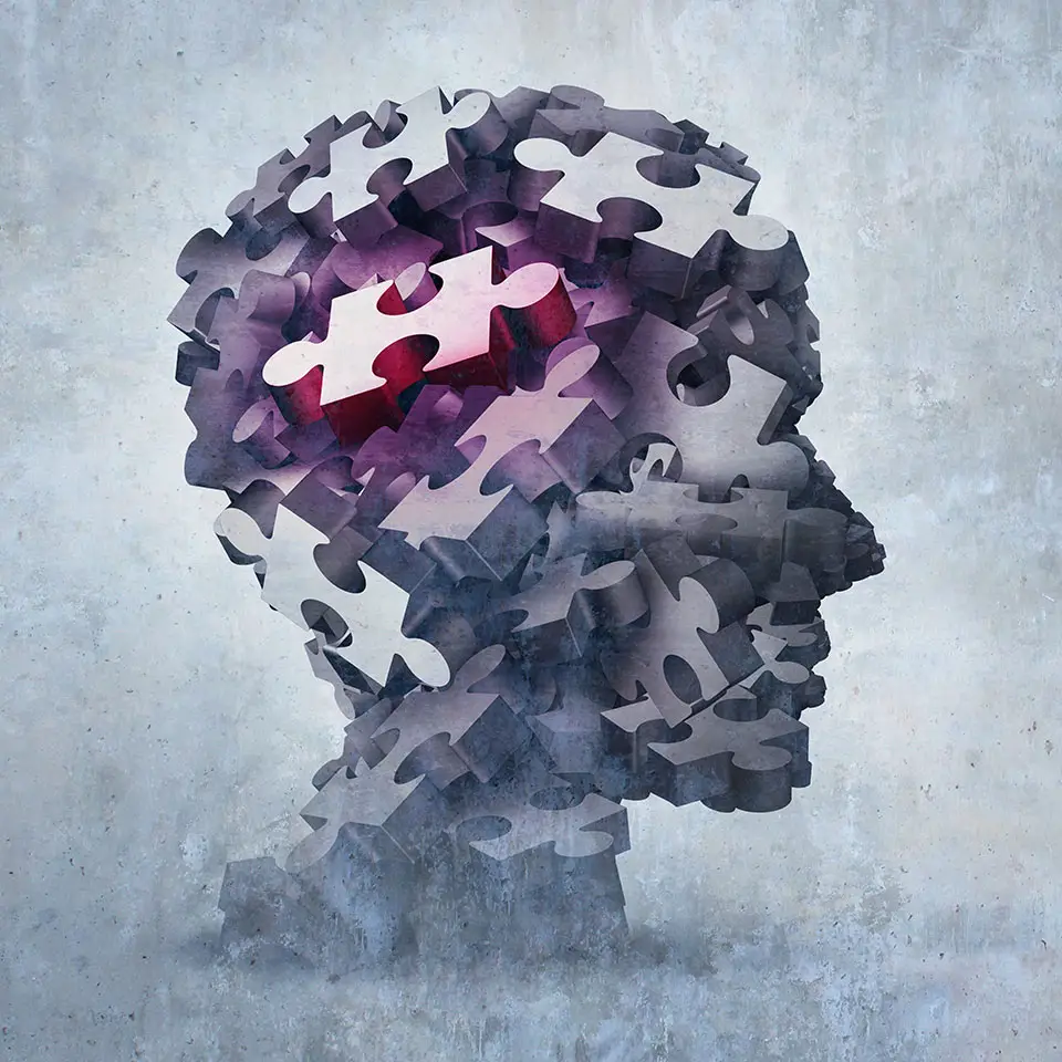 Profile of a head made up of puzzle pieces