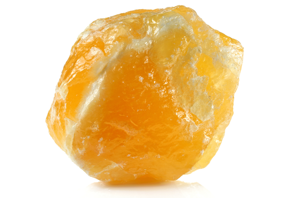 A piece of Orange Calcite on a white background