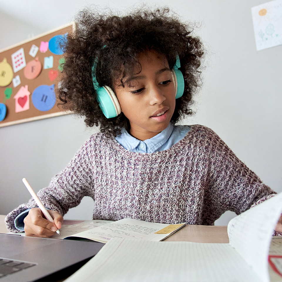 Child wearing headphones whilst working on their 4 maths course