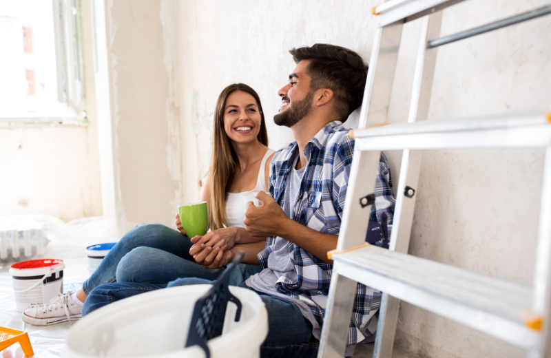south american couple decorating home
