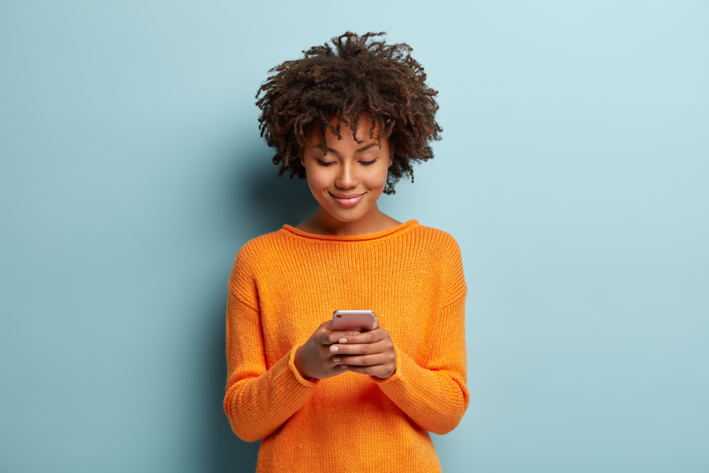 Woman smiling at her phone