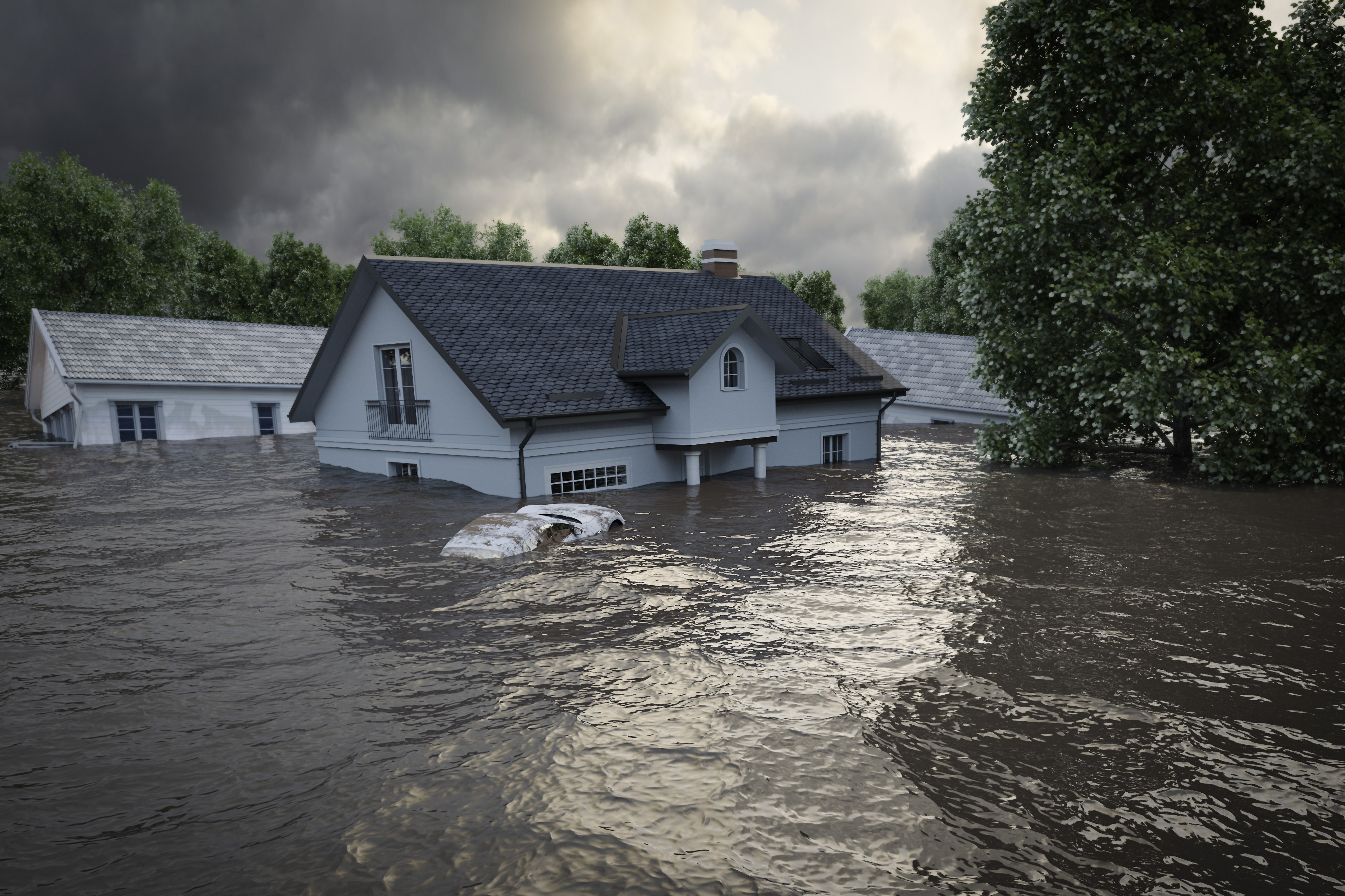 A flooded house with a car floating in the water