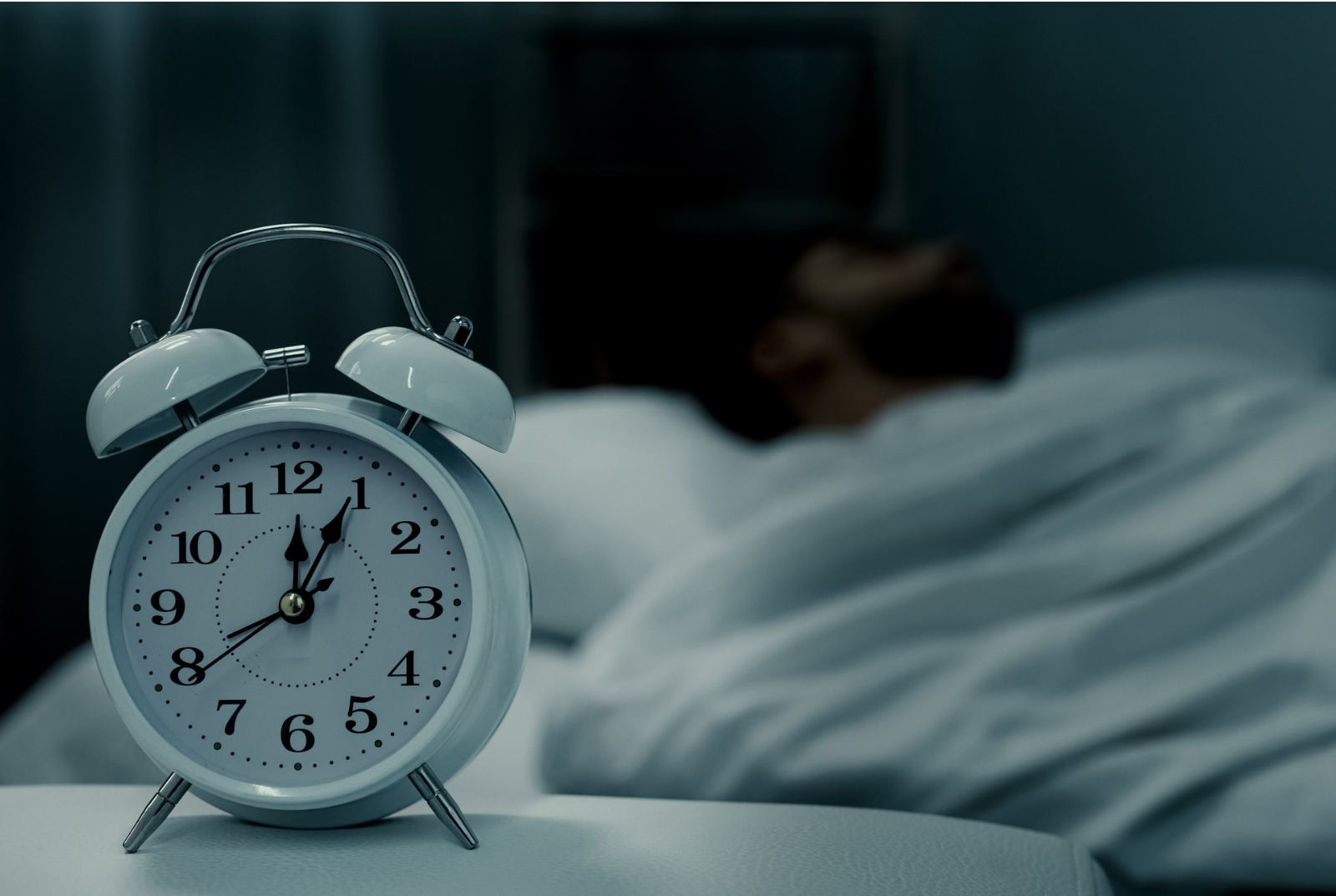 White alarm clock in dark room