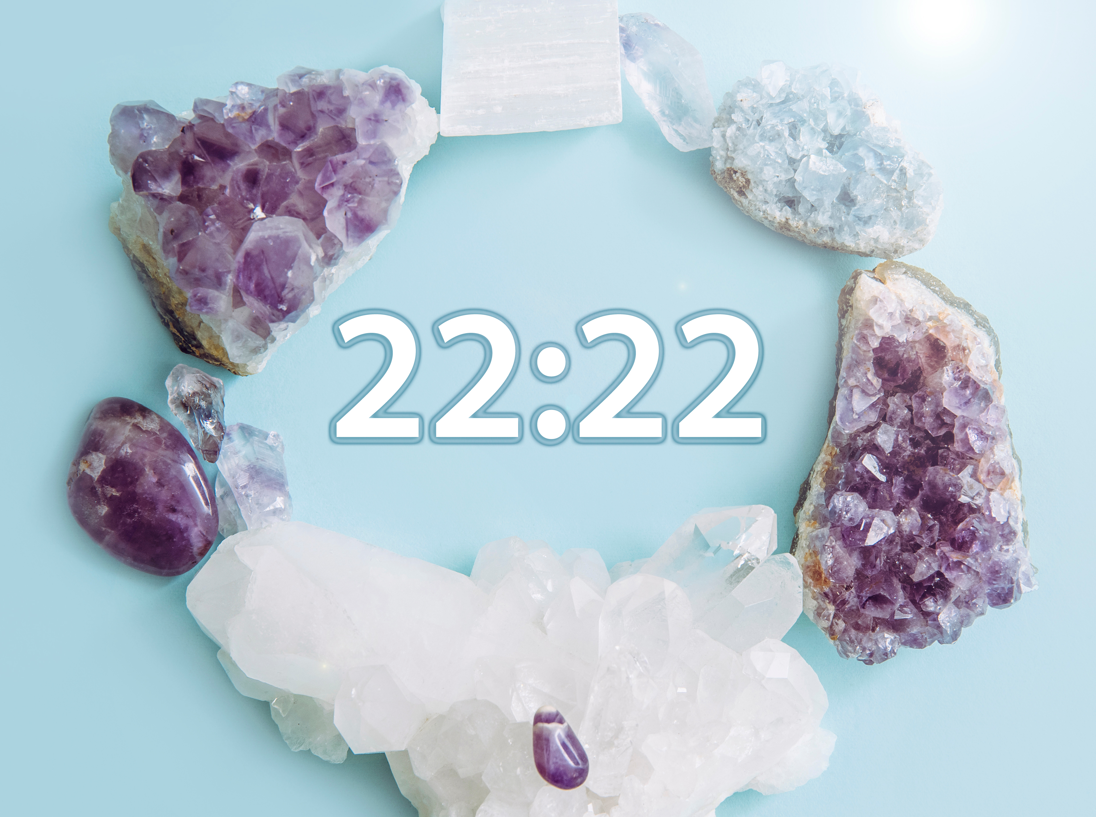 A variety of crystals placed in a circle with '22:22' written in the middle