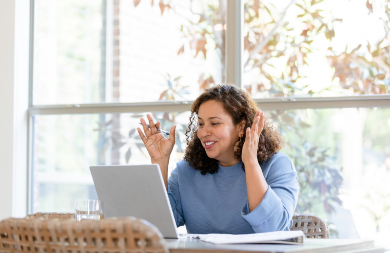Someone on an online meeting, looking positive.