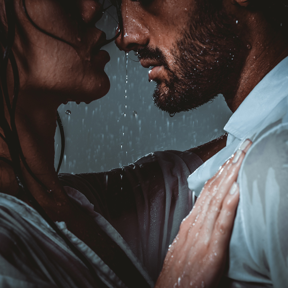 Couple sharing a romantic moment under the rain