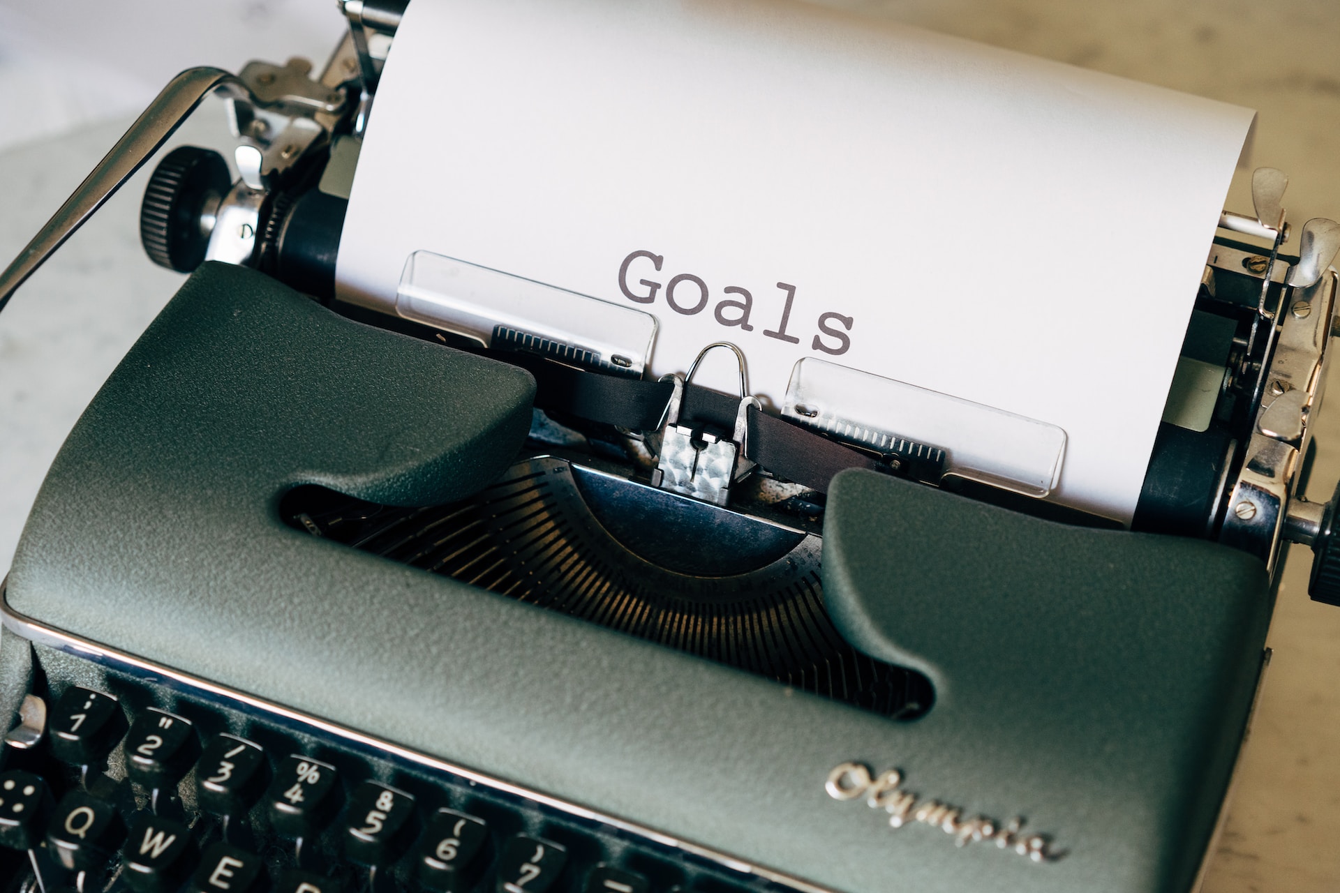 A typewriter with a sheet of paper that says "goals" on it