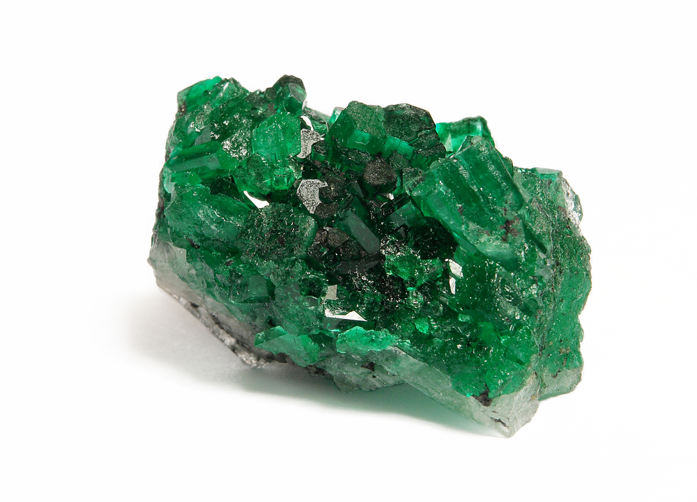 A piece of raw Emerald on a white background