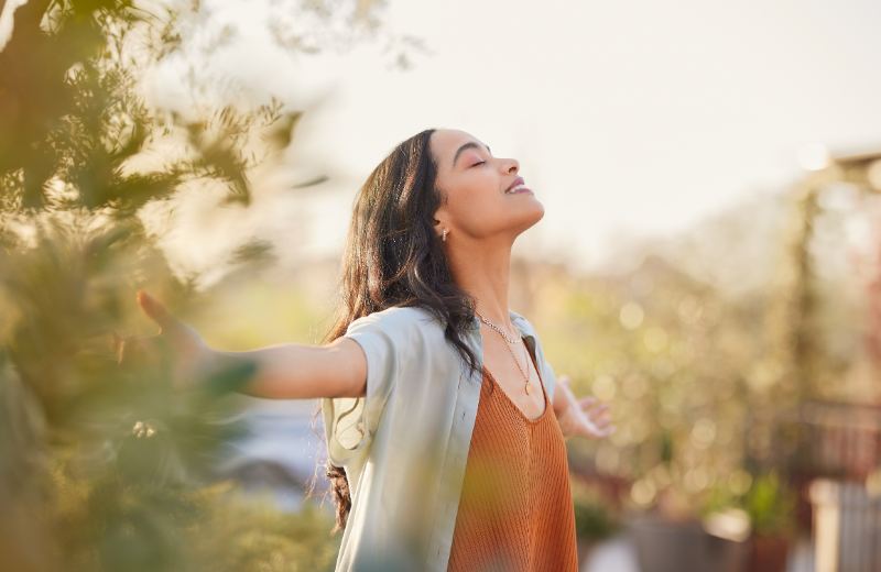 grateful woman with arms out smiling